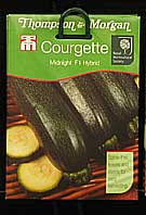 packets of courgette seeds on display at a garden centre